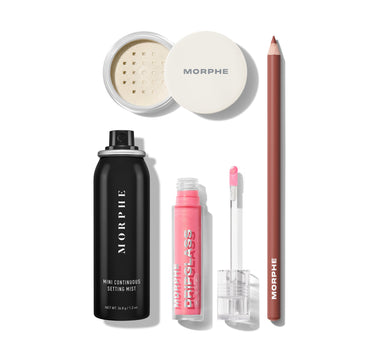 Morphe makeup products including a setting spray, powder, pencil, and lip gloss on a white background.
